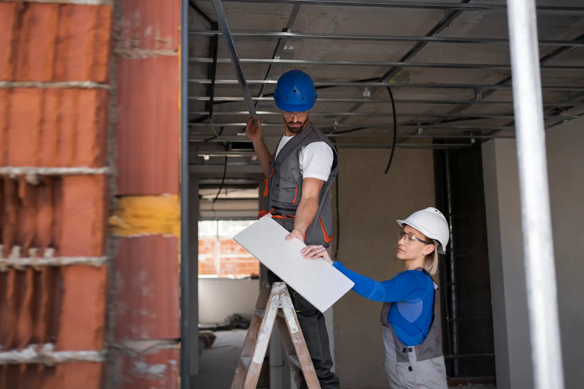 Construction workers installing panel | Apex Garage Conversions