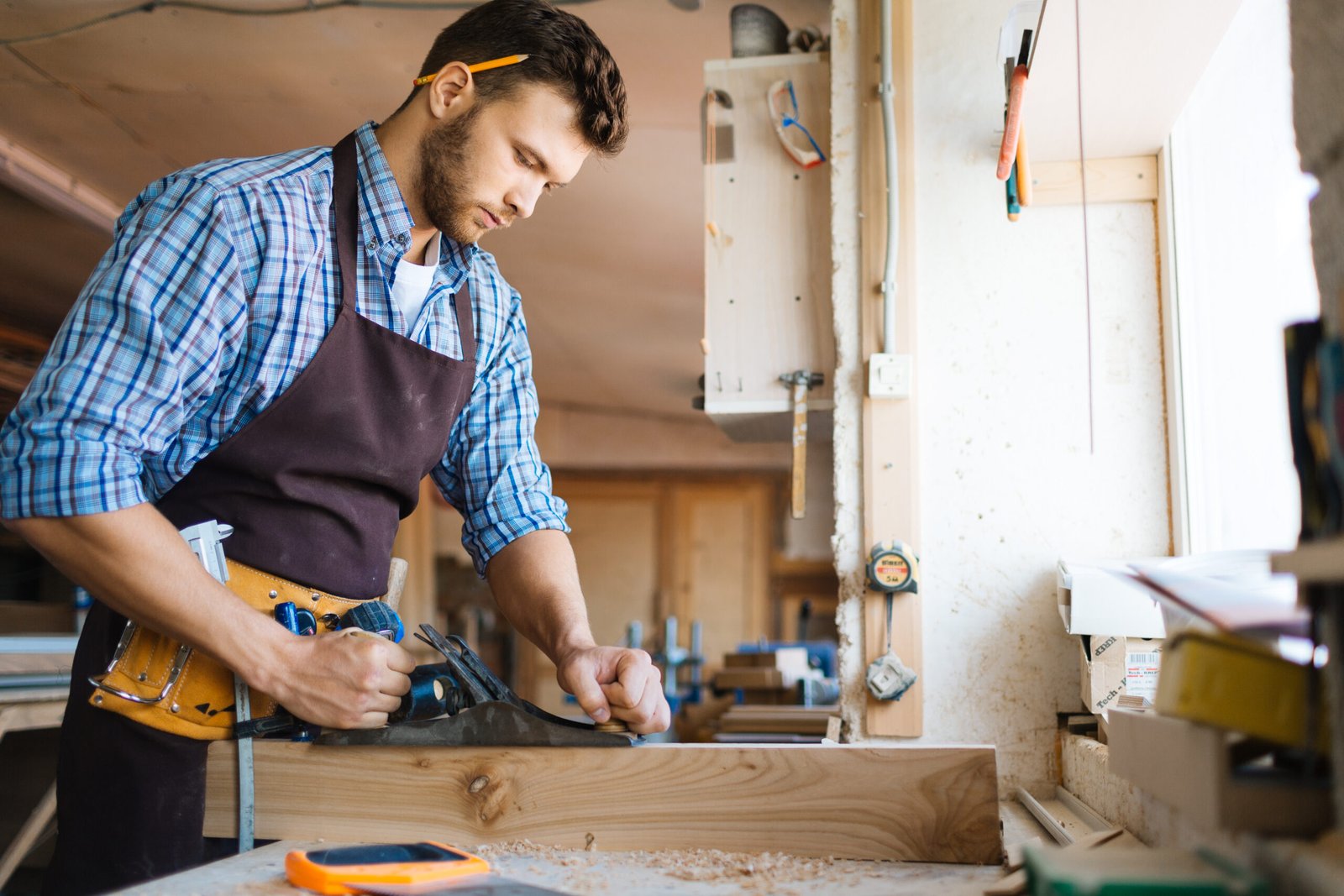 Carpenter planing a board | Apex Garage